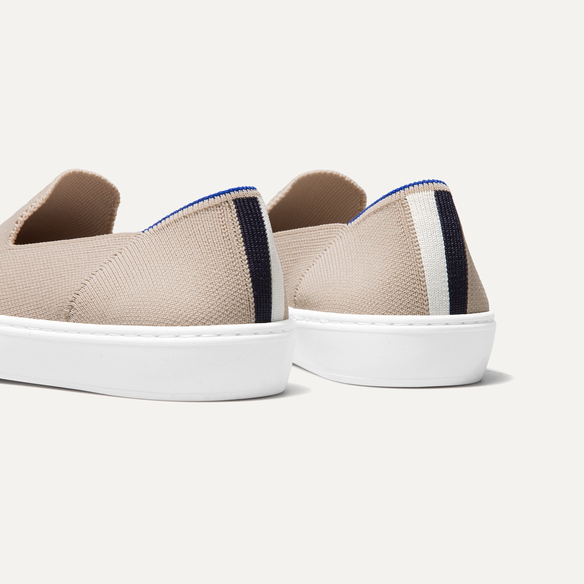 The slip-on Sneaker in Sand shown from the back view with the heel detail.