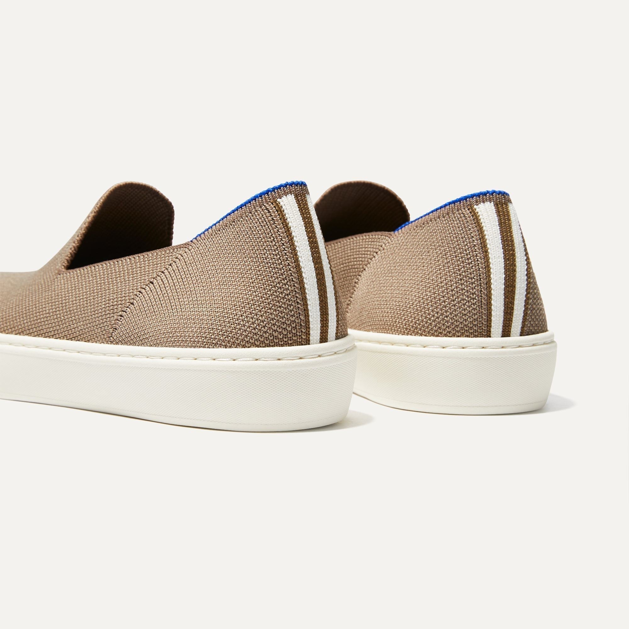 Close up of the heel of The Sneaker in Latte, with Rothy's signature blue halo. 