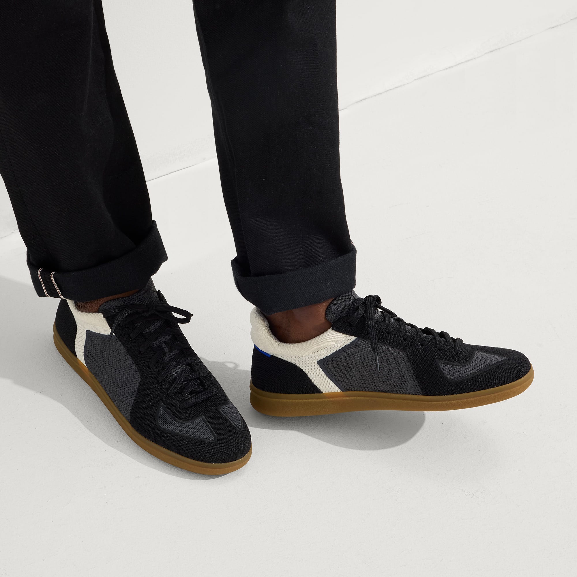 hover | Model wearing The RS01 Sneaker in Obsidian Black.