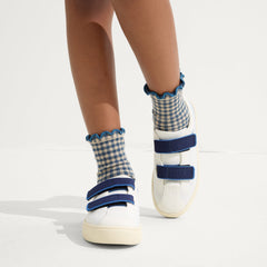 hover | A child modeling The Kids Strap Sneaker in Blue Raspberry. 