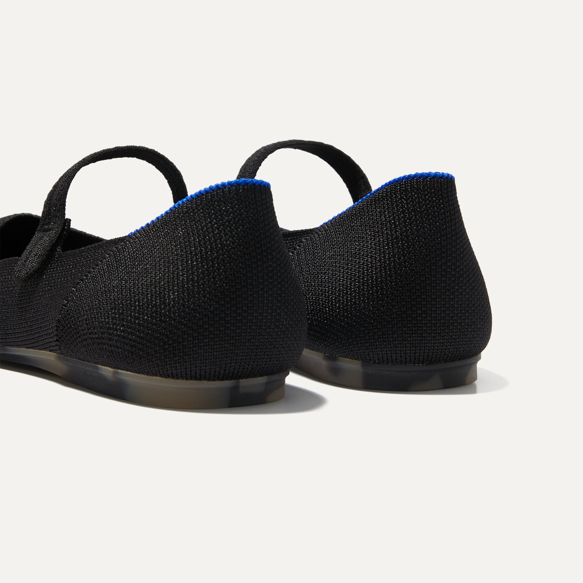 Close up of the heel of The Square Mary Jane in Black, with Rothy's signature blue halo. 