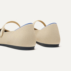 Close up of the heel of The Square Mary Jane in Cream Captoe, with Rothy's signature blue halo. 
