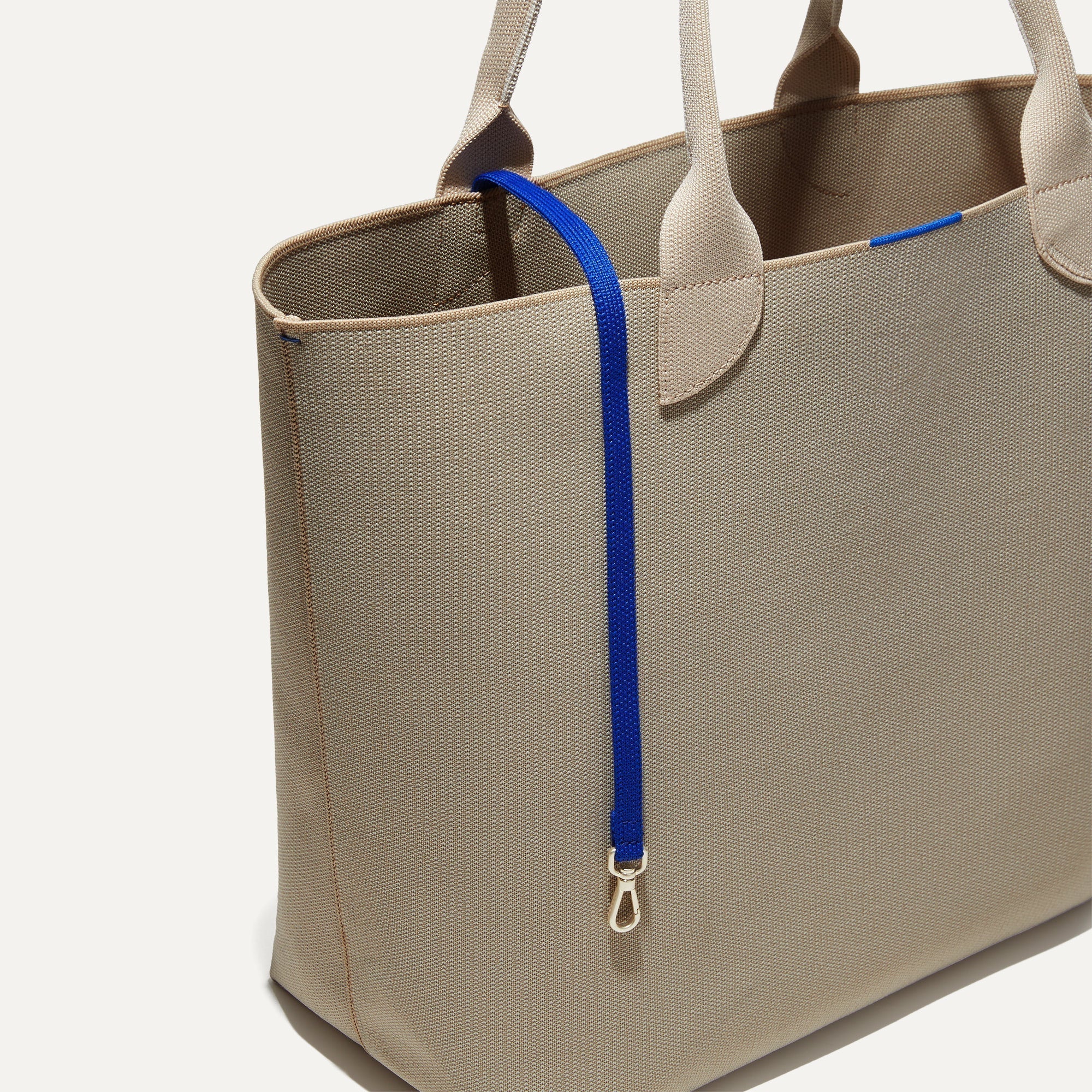 The Lighweight Tote in Soft Sesame shown with its handy key leash.