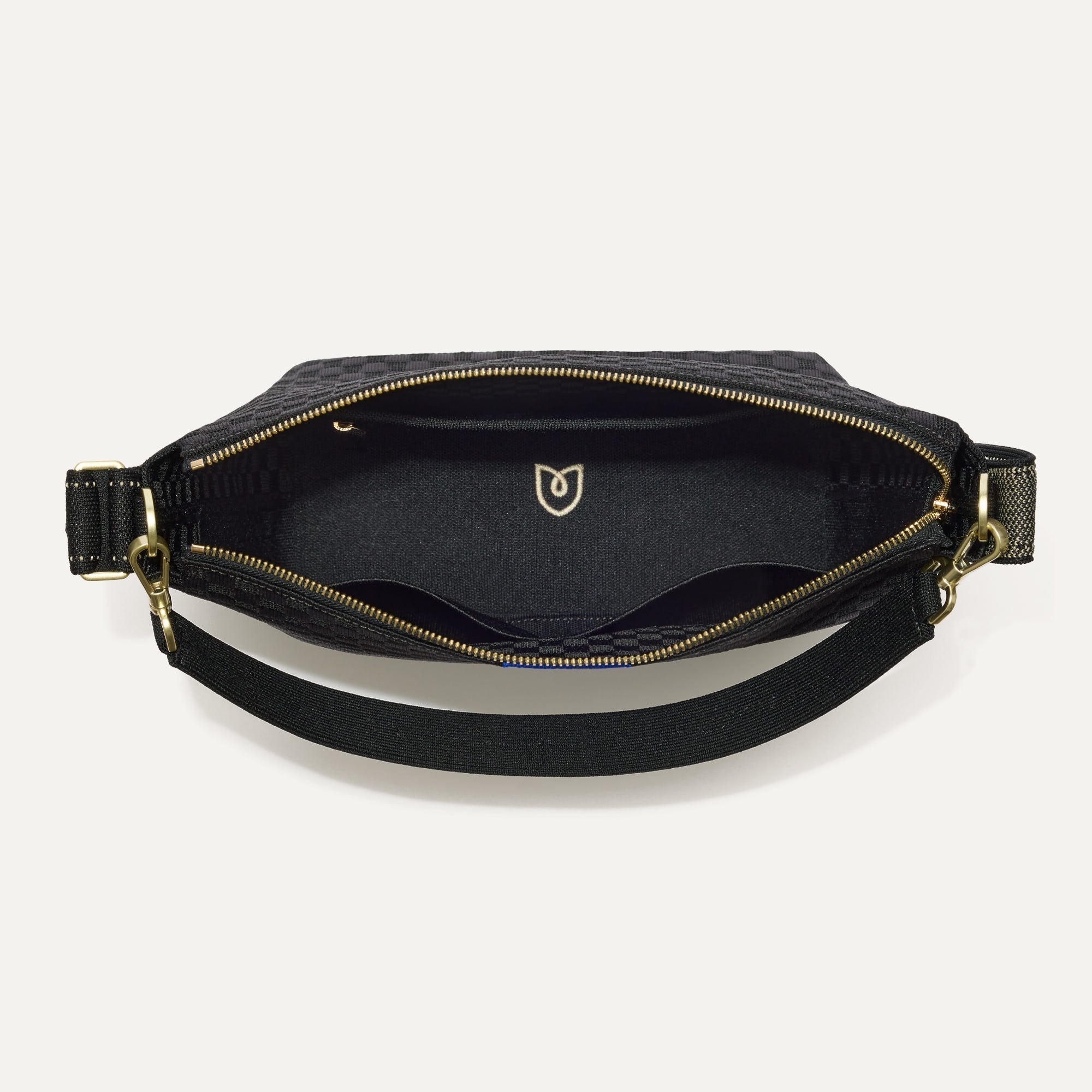 The Mini Zip Bucket in Black Sand shown from the top down, with zipper open and interior exposed.