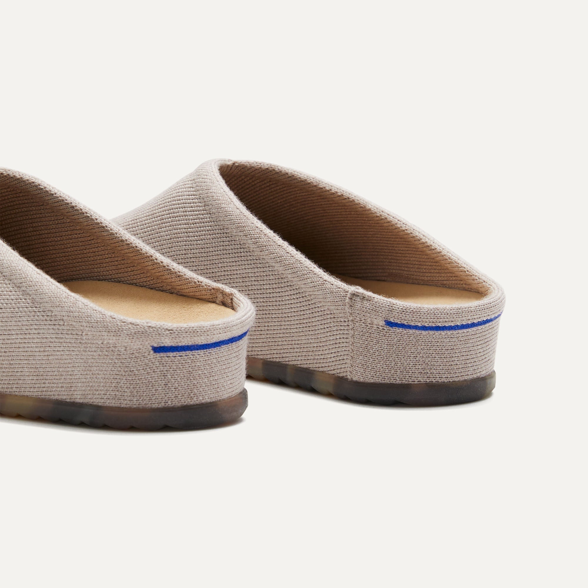 Close up of the heel of The Casual Clog in Dove, with Rothy's signature blue halo. 