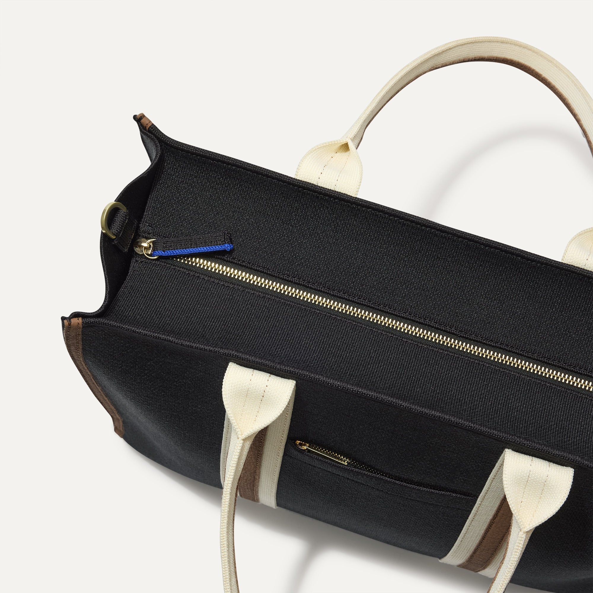 The Classic Tote in Black Coffee, shown from above, with the top zipper closed. 