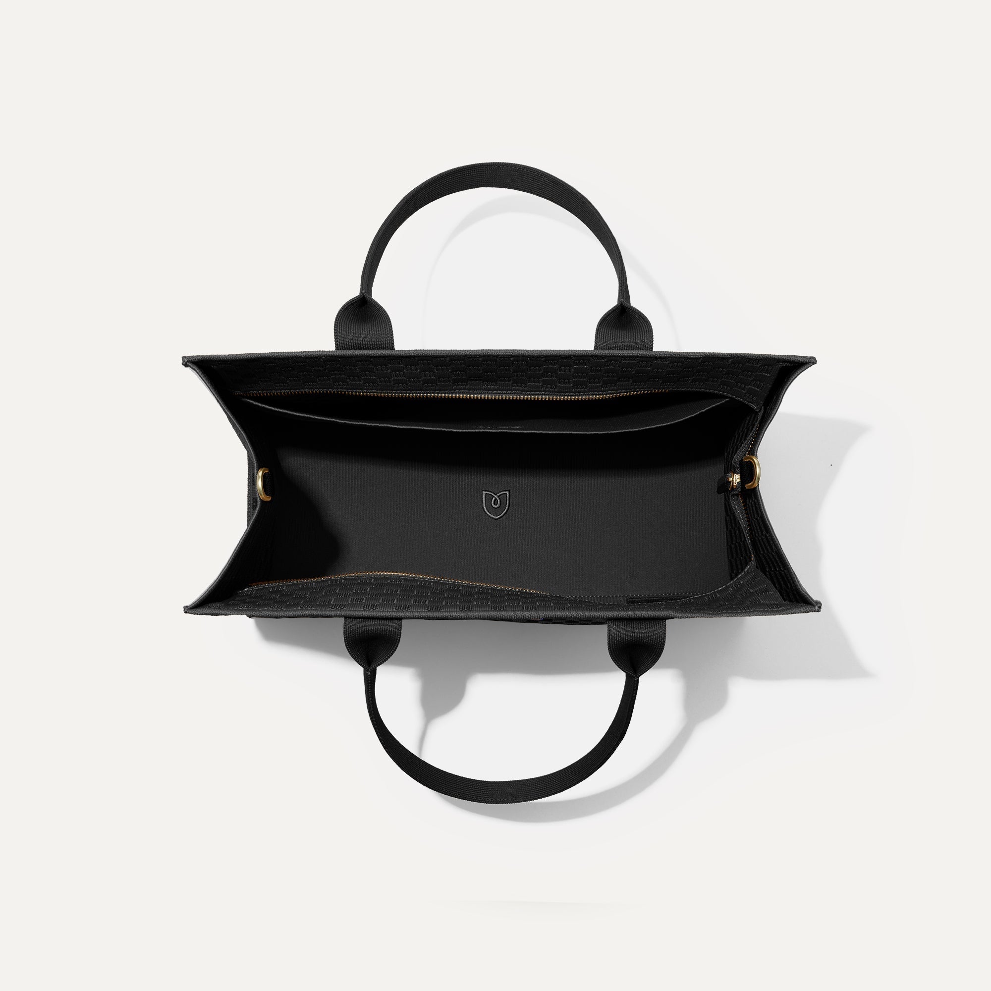 The Classic Tote in Black Sand, shown from above, with the interior exposed.