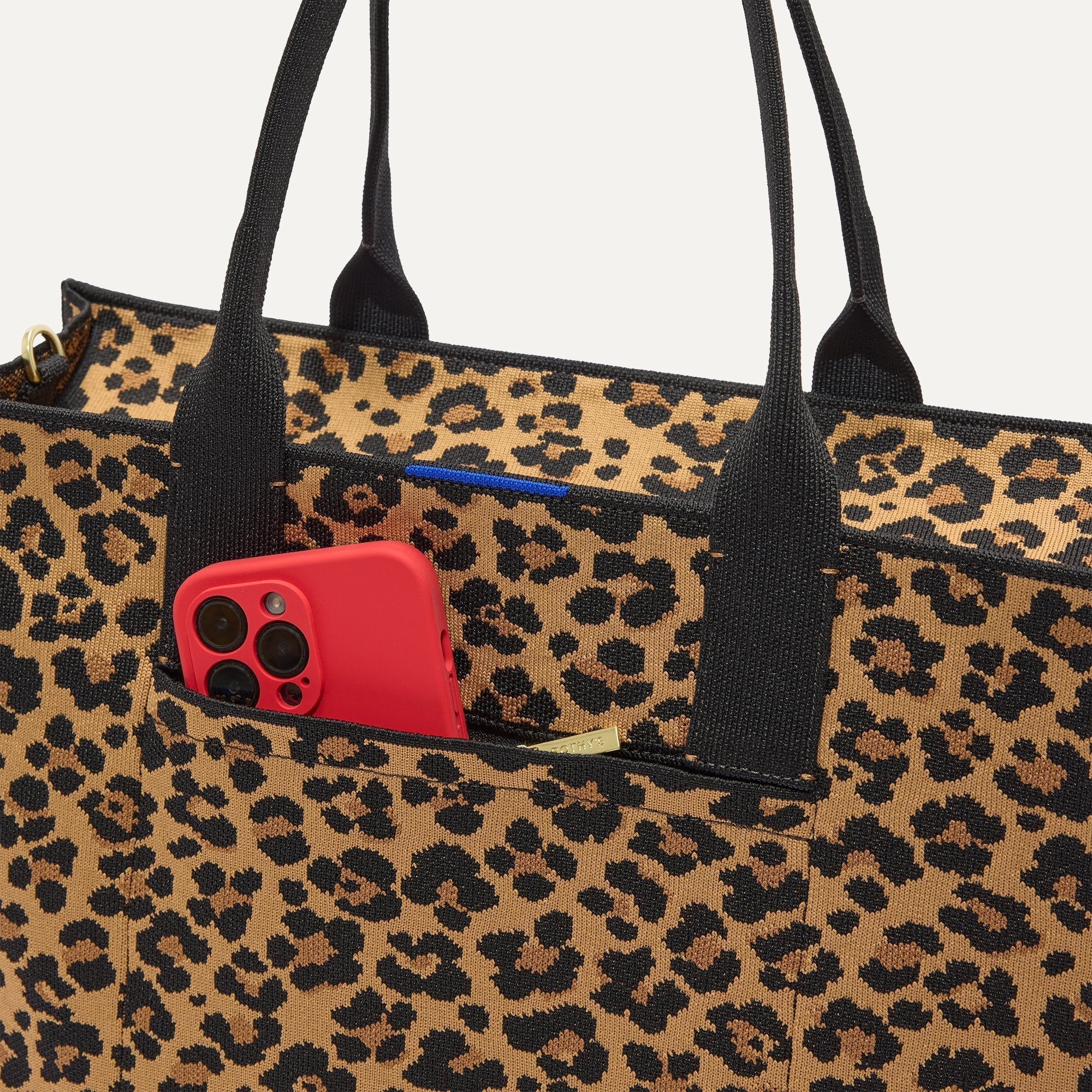 A closeup of The Classic Tote in Toasty Cat, focusing on the exterior zip pocket. 