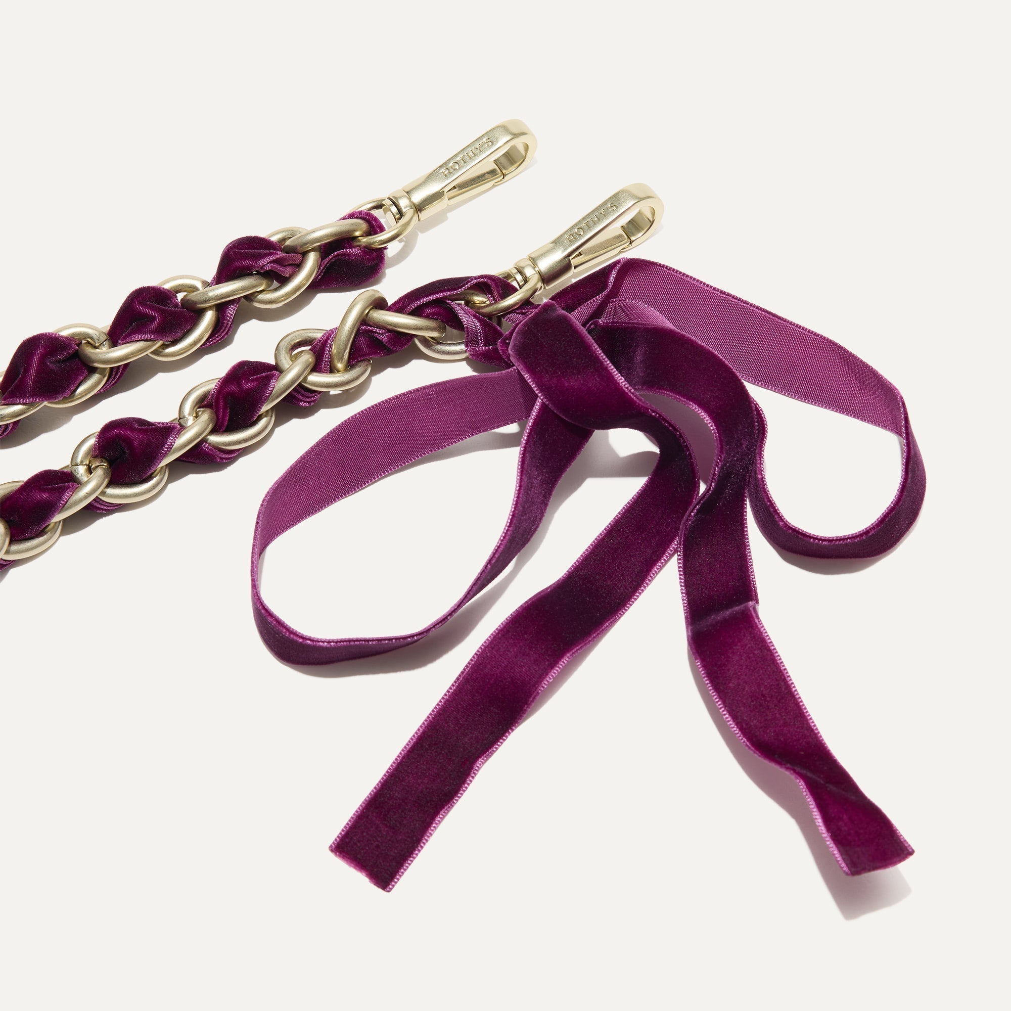 A close-up of The Shoulder Strap in Velvet Plum Chain, focusing on the end snap hooks. 
