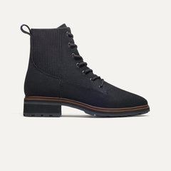 The Laced Lug Boot in Onyx Black shown from the side. 