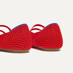 Close up of the heel of The Double Buckle Mary Jane in Bright Red Mesh, with Rothy's signature blue halo.