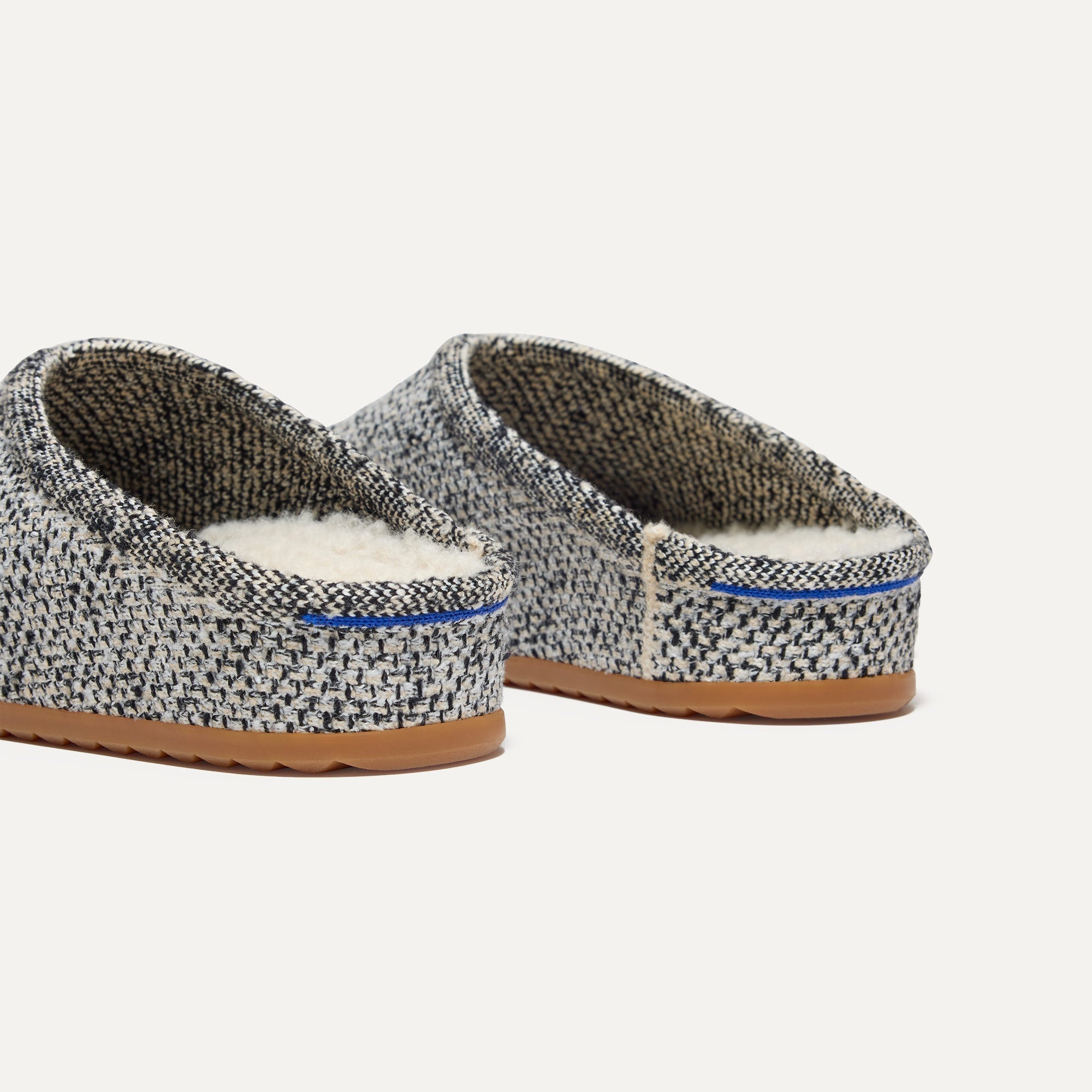 Close up of the heel of The Cozy Clog in Cookies and Cream Bouclé, with Rothy's signature blue halo. 