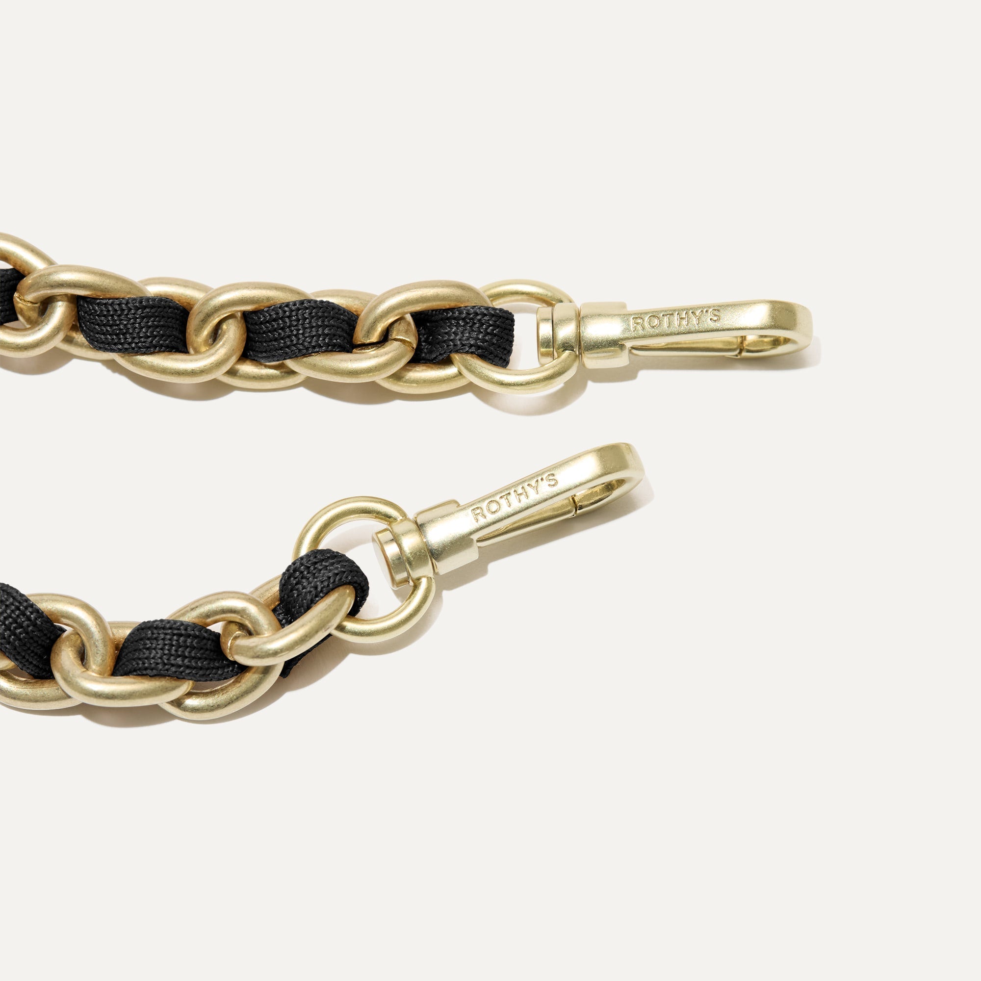 A close-up of The Crossbody Strap in Black Chain, focusing on the end snap hooks and sliding buckle.