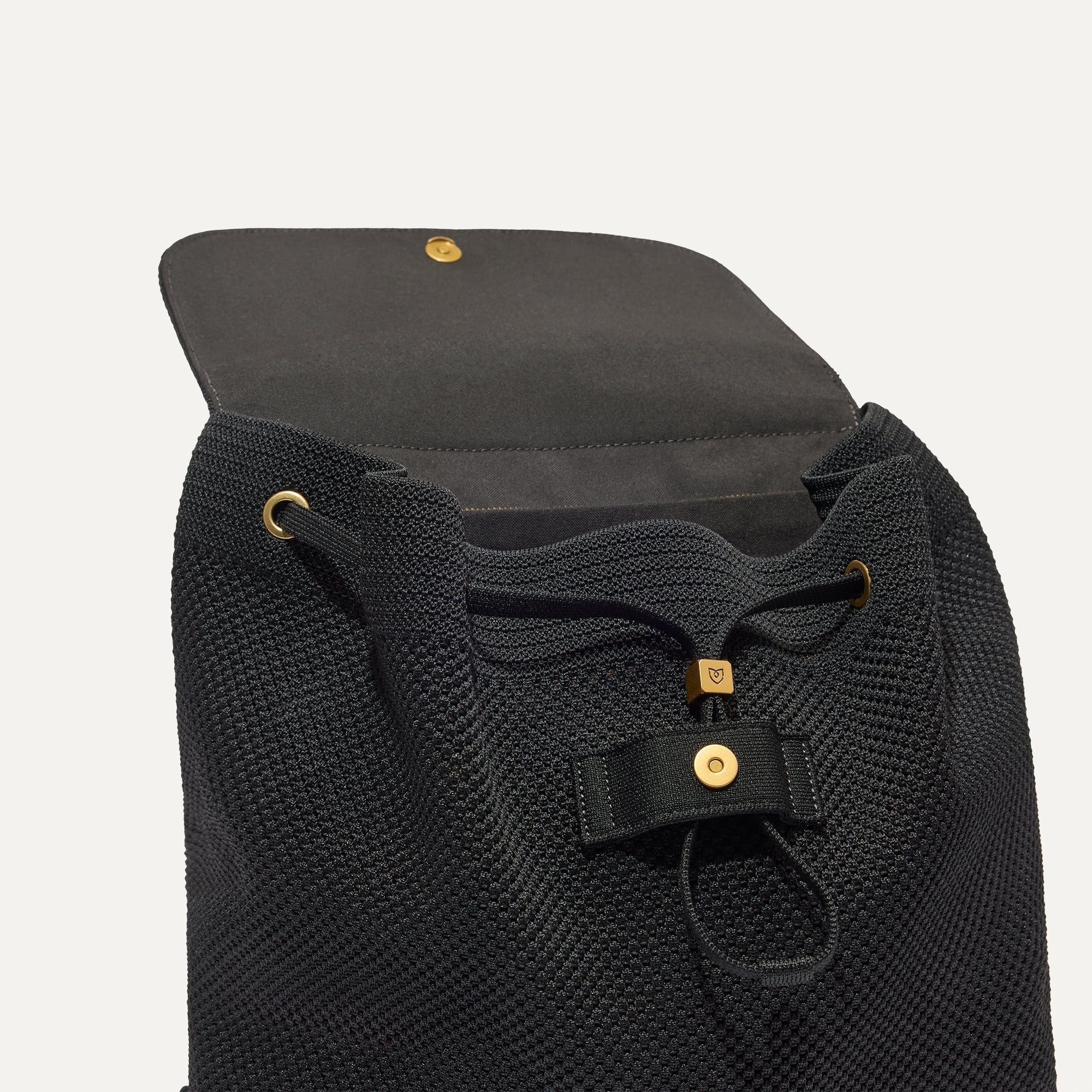 The Cinch Backpack shown with the interior exposed showing the organizational pockets.