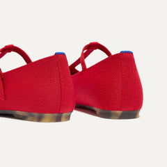 Close up of the heel of The T-Strap Mary Jane in Red Crisp, with Rothy's signature blue halo.