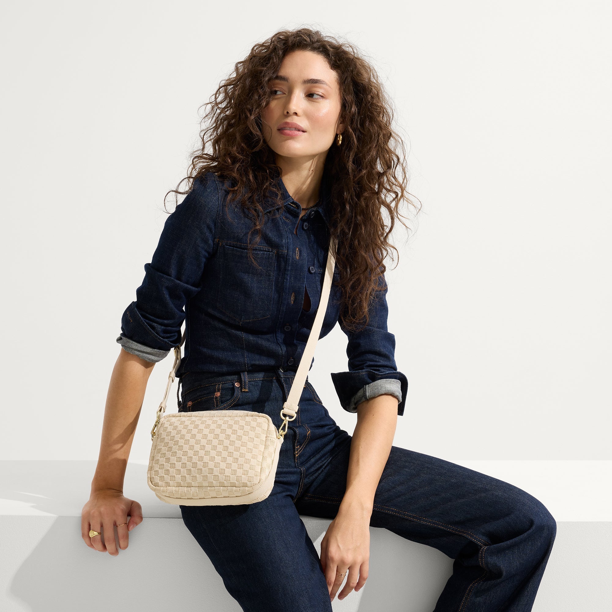 hover | The Crossbody Camera Bag in  Sesame worn as a crossbody by a model.