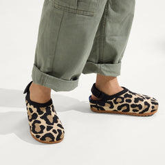 hover | A child wearing The Kids Clog in Desert Cat. 